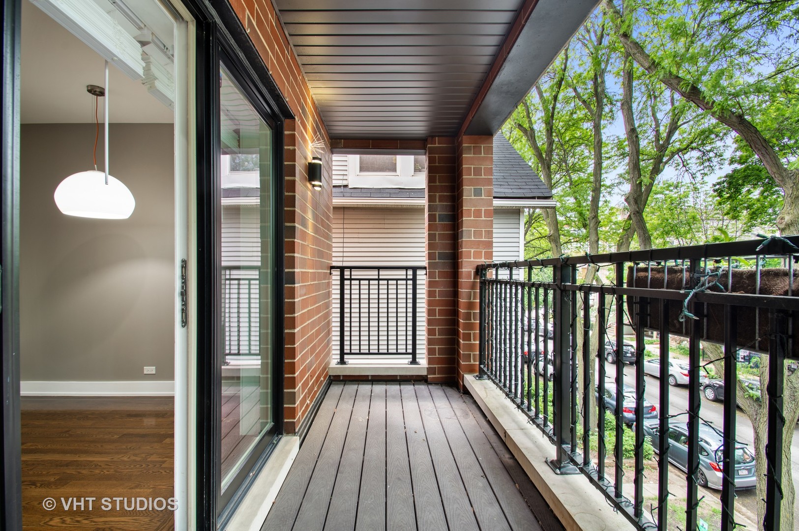 1741 West Roscoe Street, Unit 2 Chicago, IL 60657 - Photo 23 of 24 a view of a balcony with wooden floor