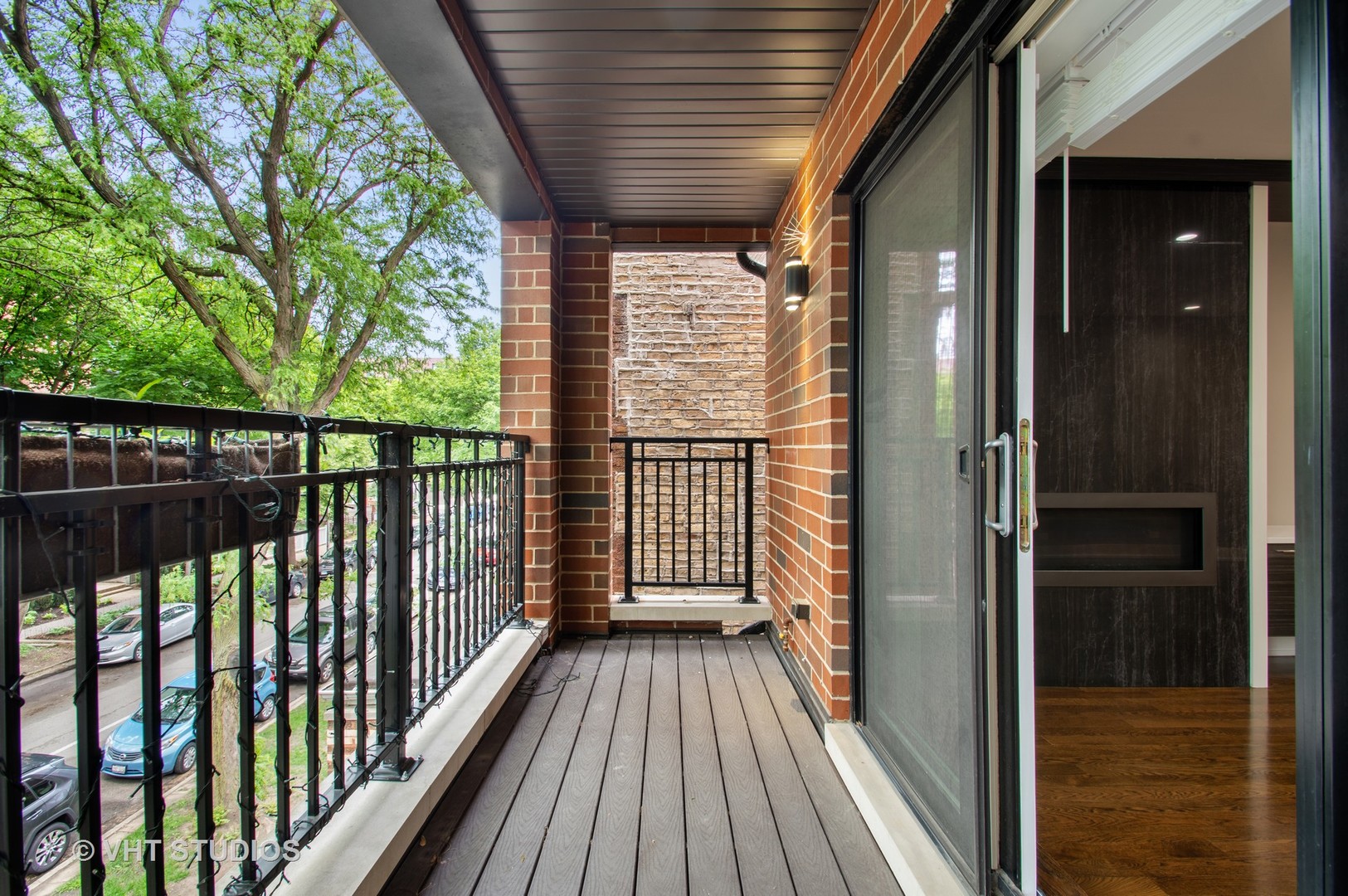 1741 West Roscoe Street, Unit 2 Chicago, IL 60657 - Photo 24 of 24 a view of a balcony with wooden floor