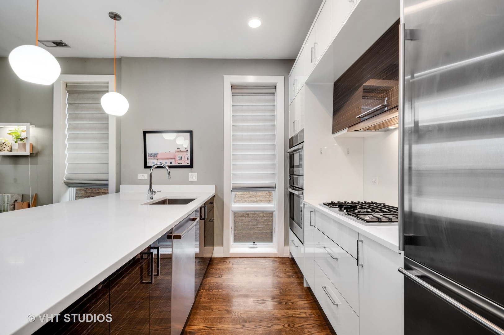 1741 West Roscoe Street, Unit 2 Chicago, IL 60657 - Photo 5 of 24 a kitchen with a sink stainless steel appliances and cabinets