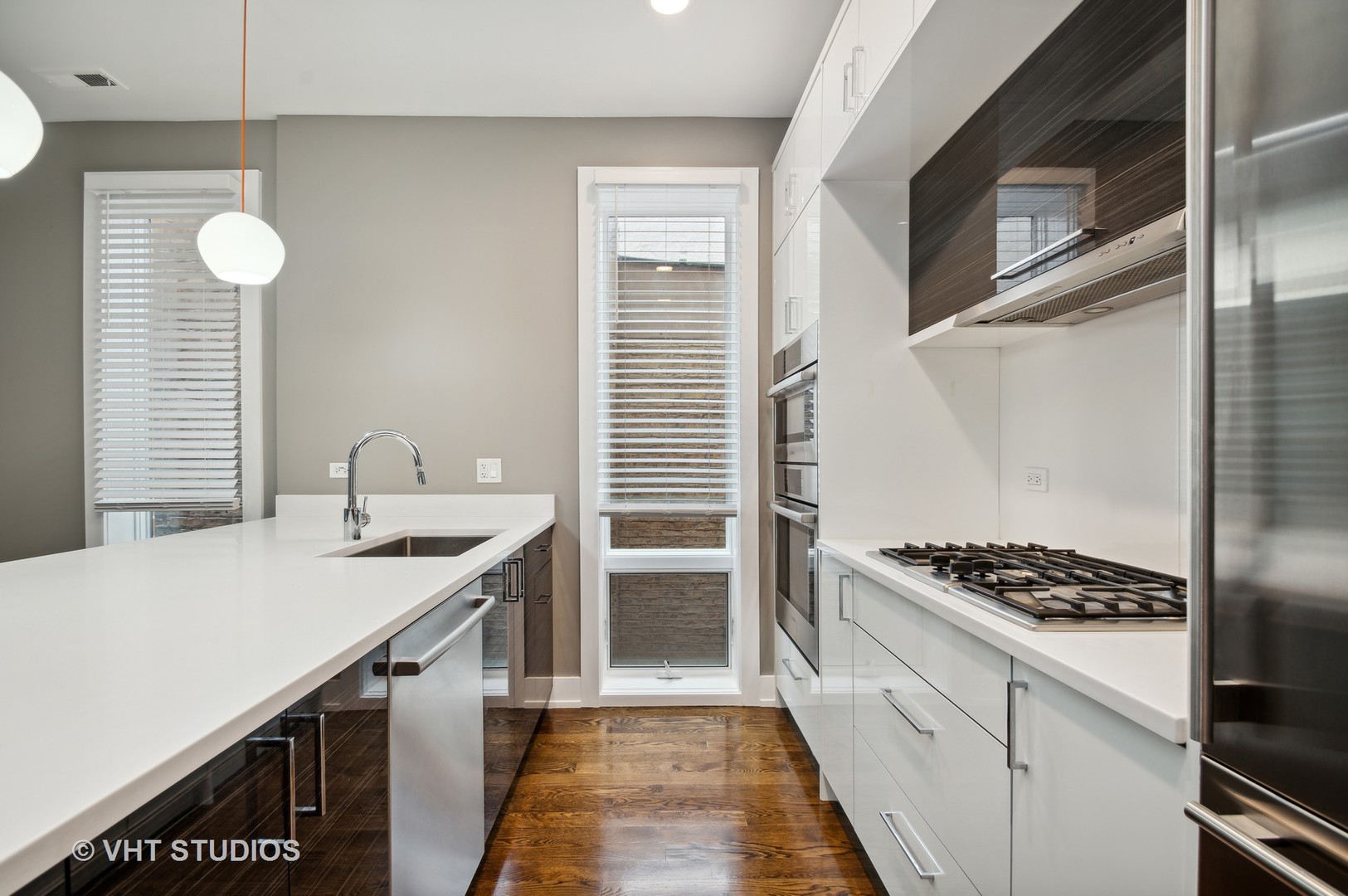 1741 West Roscoe Street, Unit 2 Chicago, IL 60657 - Photo 9 of 24 a kitchen that has a sink and a stove