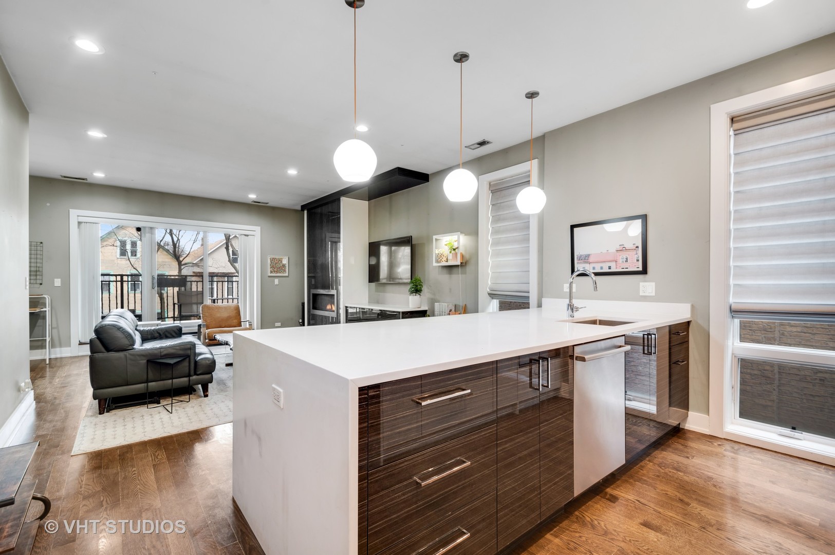 1741 West Roscoe Street, Unit 2 Chicago, IL 60657 - Photo 10 of 24 a large kitchen with kitchen island a large island in it