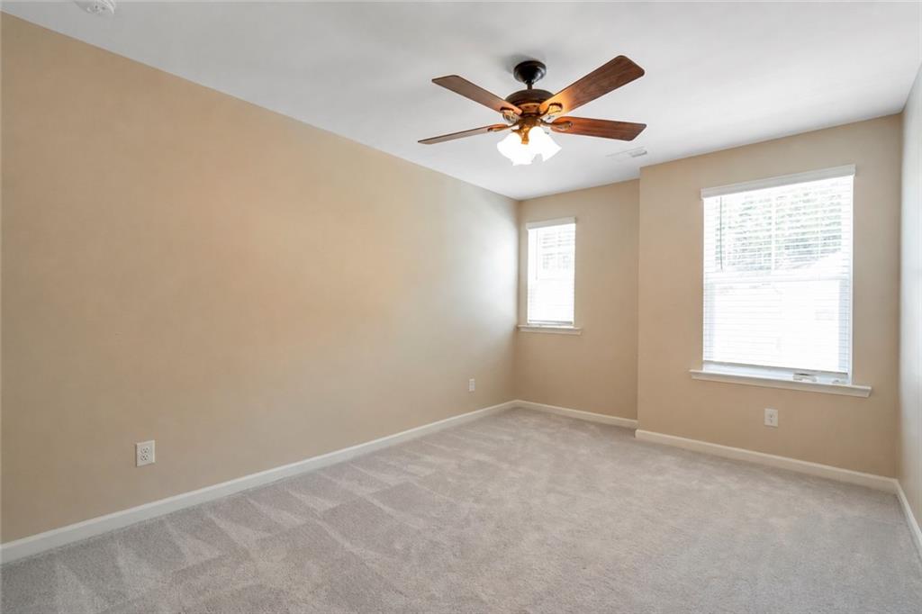 660 Groover Street Ball Ground, GA 30107 - Photo 33 of 53 a view of a big room with a chandelier fan and windows