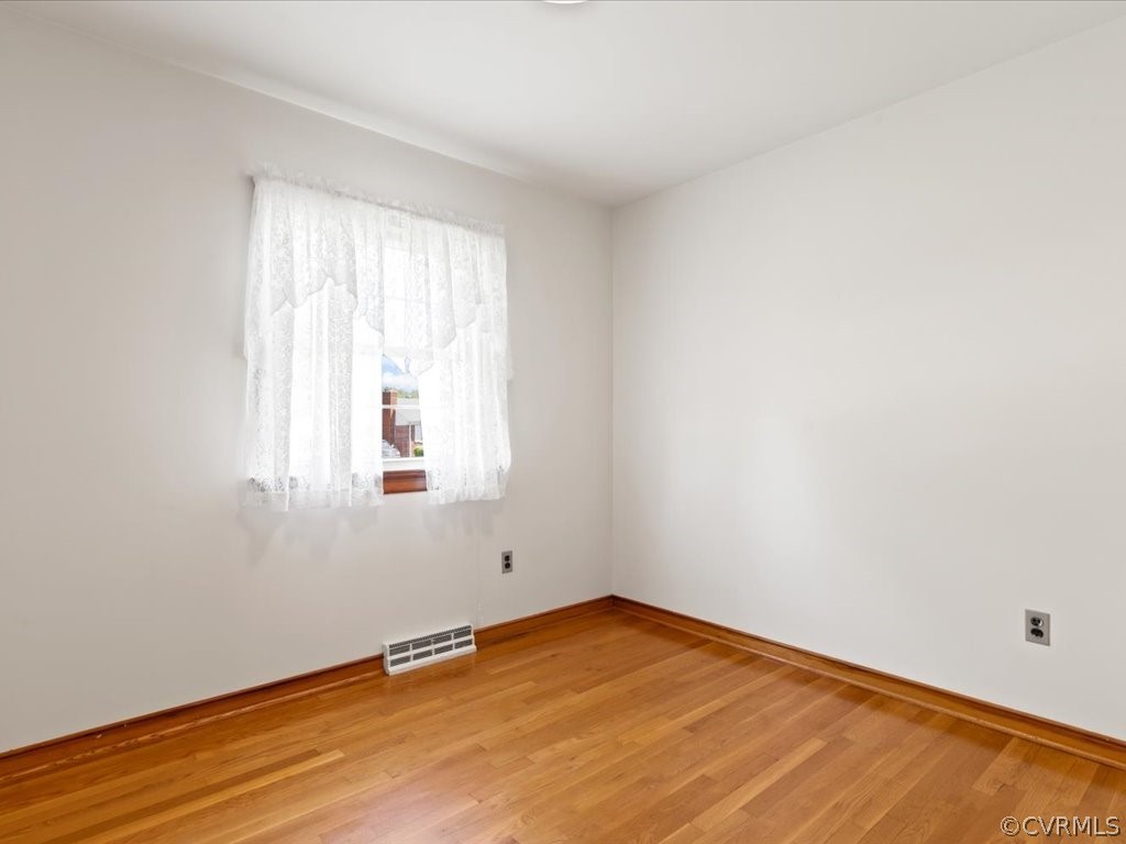 6401 Commander Road Richmond, VA 23224 - Photo 11 of 19 an empty room with wooden floor and windows