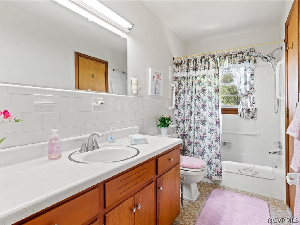 6401 Commander Road Richmond, VA 23224 - Photo 8 of 19 a bathroom with a sink toilet and shower
