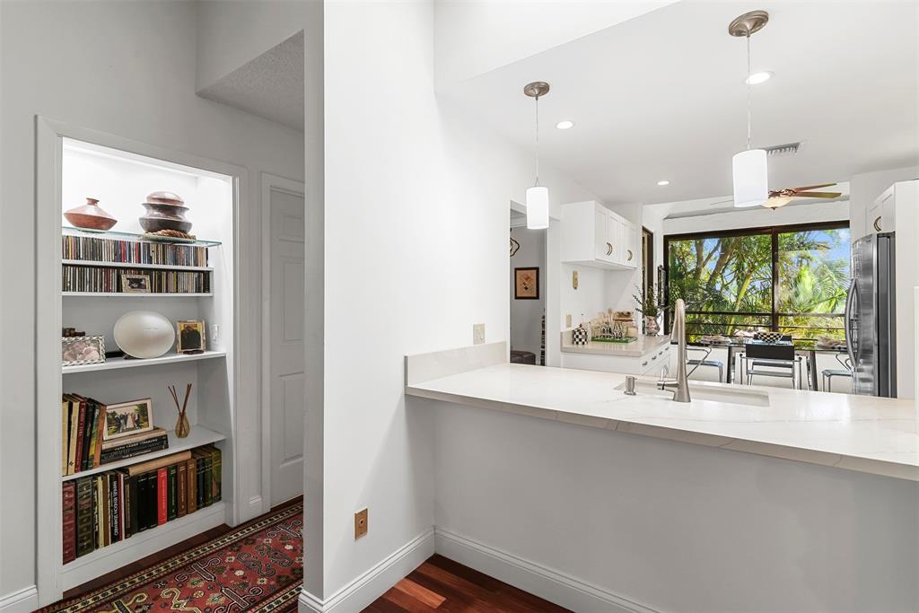7535 La Paz Boulevard, Unit 301 Boca Raton, FL 33433 - Photo 13 of 42 a room with stainless steel appliances a sink a window and cabinets