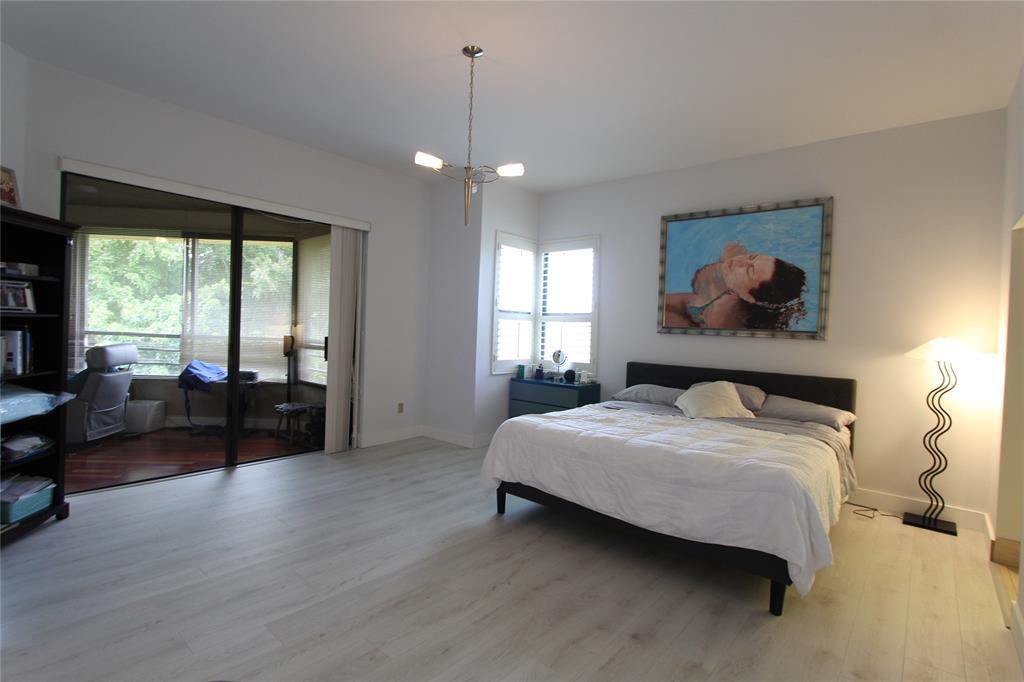 7535 La Paz Boulevard, Unit 301 Boca Raton, FL 33433 - Photo 14 of 42 a bedroom with a bed and wooden floor