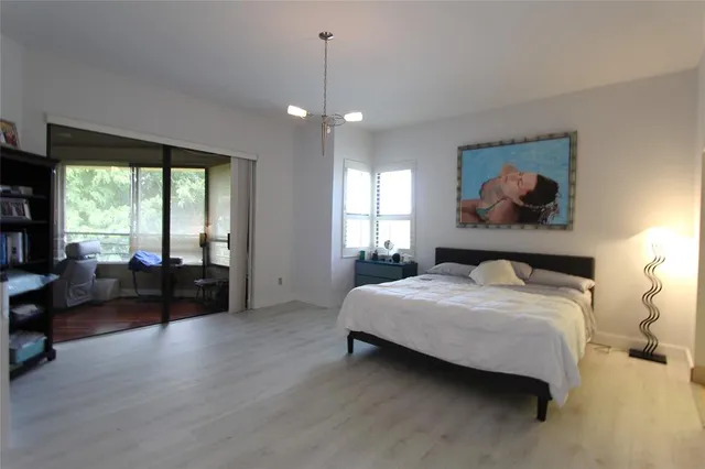 a bedroom with a bed a couch and a window