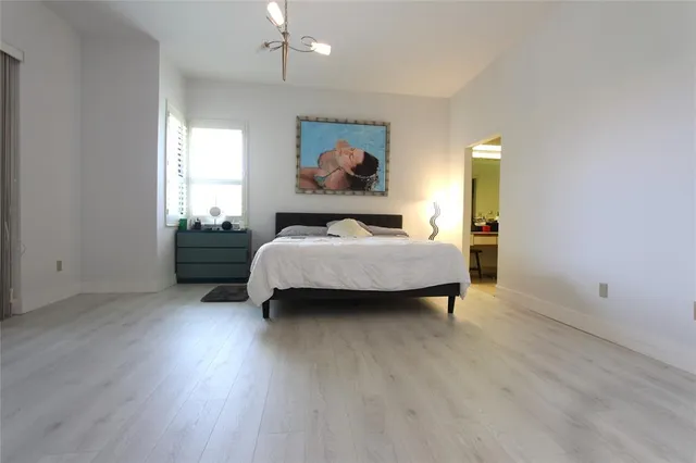 an aerial view of a house with a yard and lake view