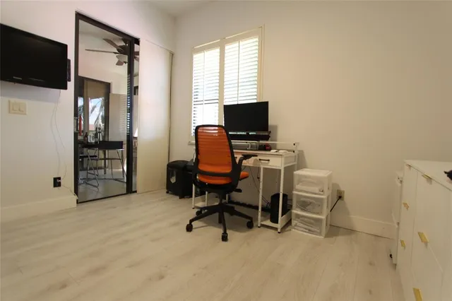 a view of a livingroom with workspace and a window