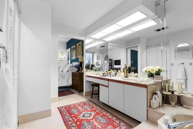 a room with stainless steel appliances kitchen island granite countertop a sink and cabinets