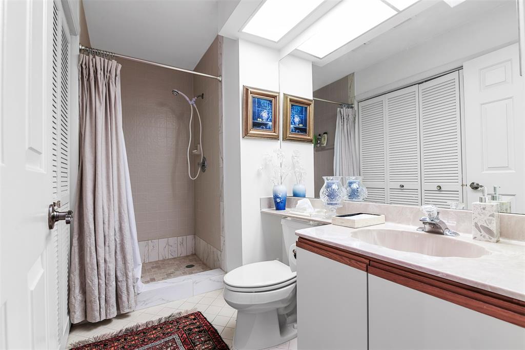 7535 La Paz Boulevard, Unit 301 Boca Raton, FL 33433 - Photo 25 of 42 a bathroom with a sink a toilet and shower