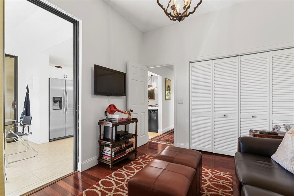 7535 La Paz Boulevard, Unit 301 Boca Raton, FL 33433 - Photo 26 of 42 a living room with furniture and a flat screen tv