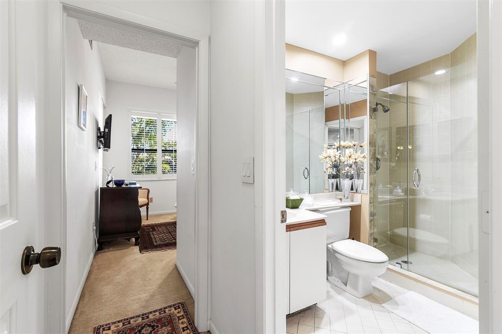 7535 La Paz Boulevard, Unit 301 Boca Raton, FL 33433 - Photo 27 of 42 a bathroom with a sink a toilet and a shower