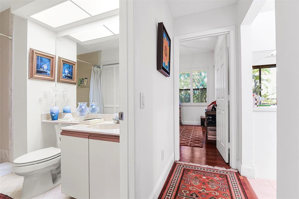 7535 La Paz Boulevard, Unit 301 Boca Raton, FL 33433 - Photo 29 of 42 a bathroom with a sink toilet and shower