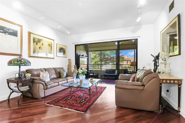 a living room with furniture and large windows