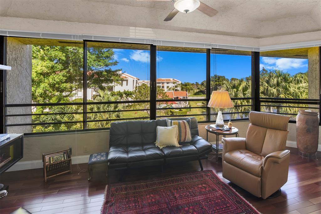 7535 La Paz Boulevard, Unit 301 Boca Raton, FL 33433 - Photo 9 of 42 a living room with furniture city view and large windows