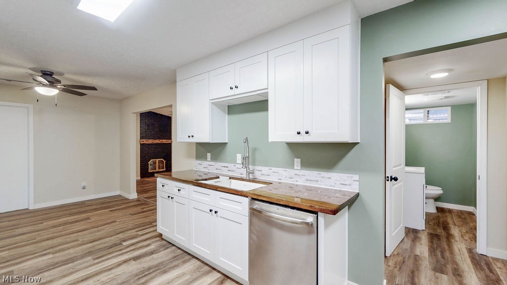 18620 Shaw Road Chagrin Falls, OH 44023 - Photo 11 of 44 Kitchenette featuring white shaker cabinetry, wood-finish countertops, stainless steel dishwasher, and a white tile backsplash