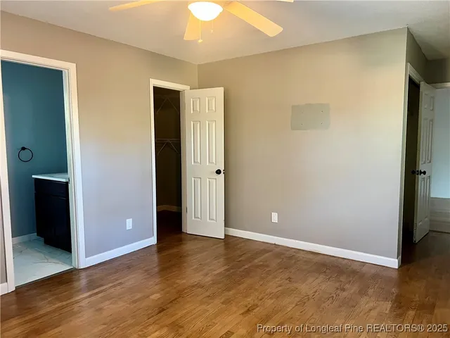 an empty room with wooden floor and closet