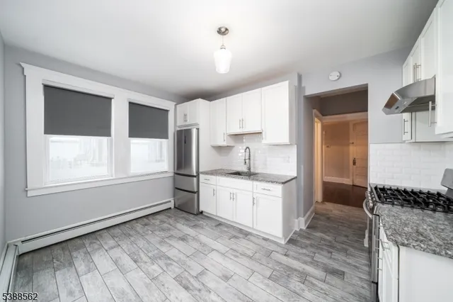 a kitchen with a stove a sink and a refrigerator