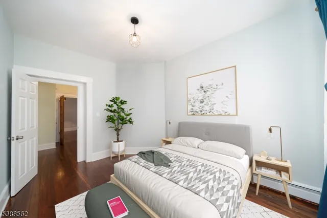 a bedroom with a bed and a potted plant