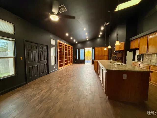 a large kitchen with stainless steel appliances a large counter top