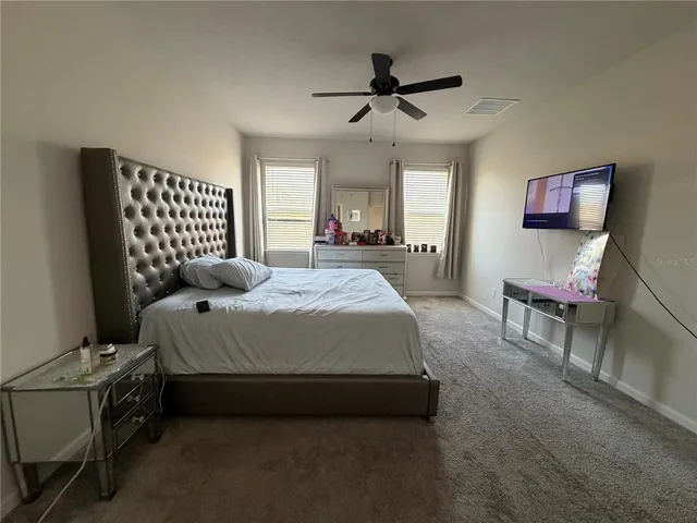 a bedroom with a bed and a chandelier