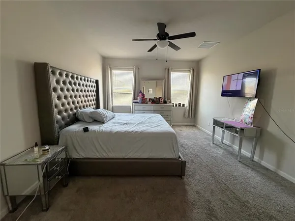 a bedroom with a bed and a chandelier