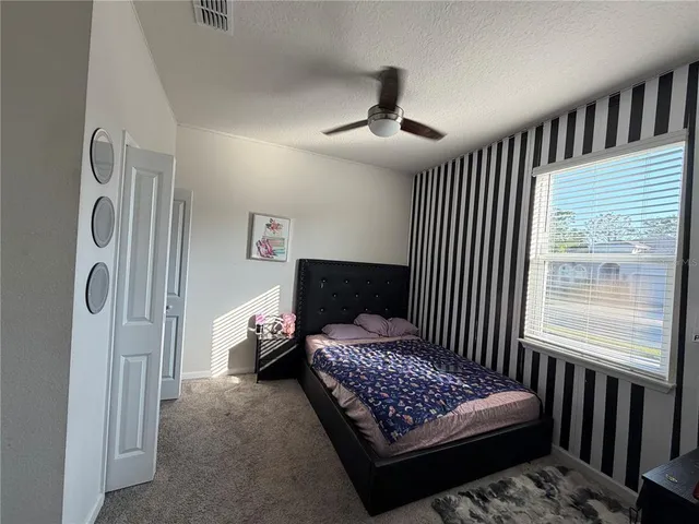 a bedroom with bed and a window