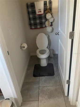 a bathroom with a toilet and a mirror