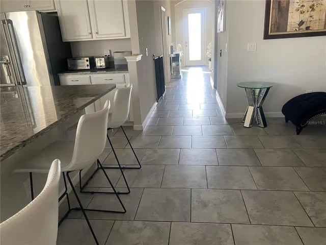 a kitchen with stainless steel appliances a refrigerator a sink a stove a microwave and cabinets