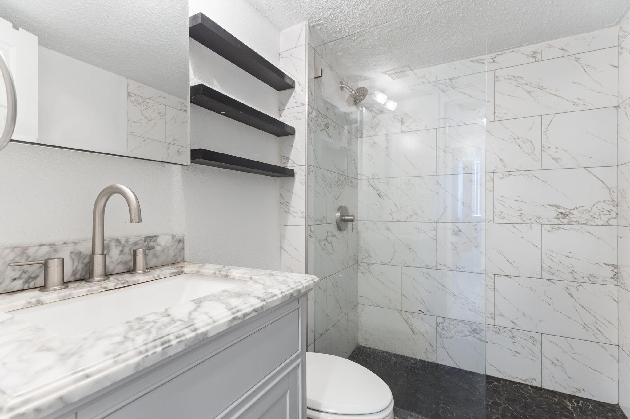 1500 Bay Road, Unit 1122S Miami Beach, FL 33139 - Photo 16 of 24 a bathroom with a granite countertop sink a toilet and shower