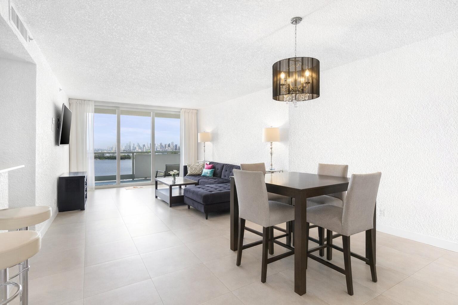 1500 Bay Road, Unit 1122S Miami Beach, FL 33139 - Photo 2 of 24 a dining room with furniture a chandelier and window