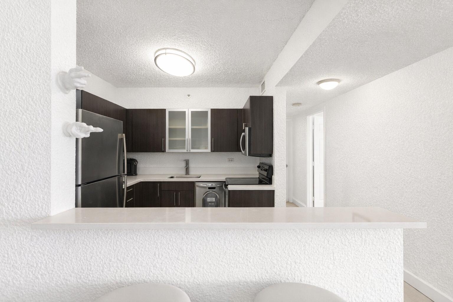 1500 Bay Road, Unit 1122S Miami Beach, FL 33139 - Photo 3 of 24 a large white kitchen with a large window