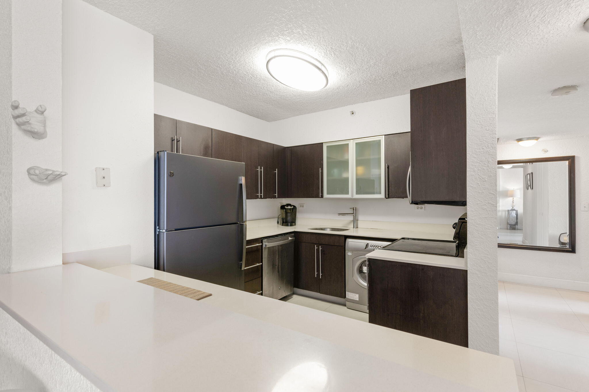 1500 Bay Road, Unit 1122S Miami Beach, FL 33139 - Photo 5 of 24 a kitchen with stainless steel appliances kitchen island a refrigerator sink and stove