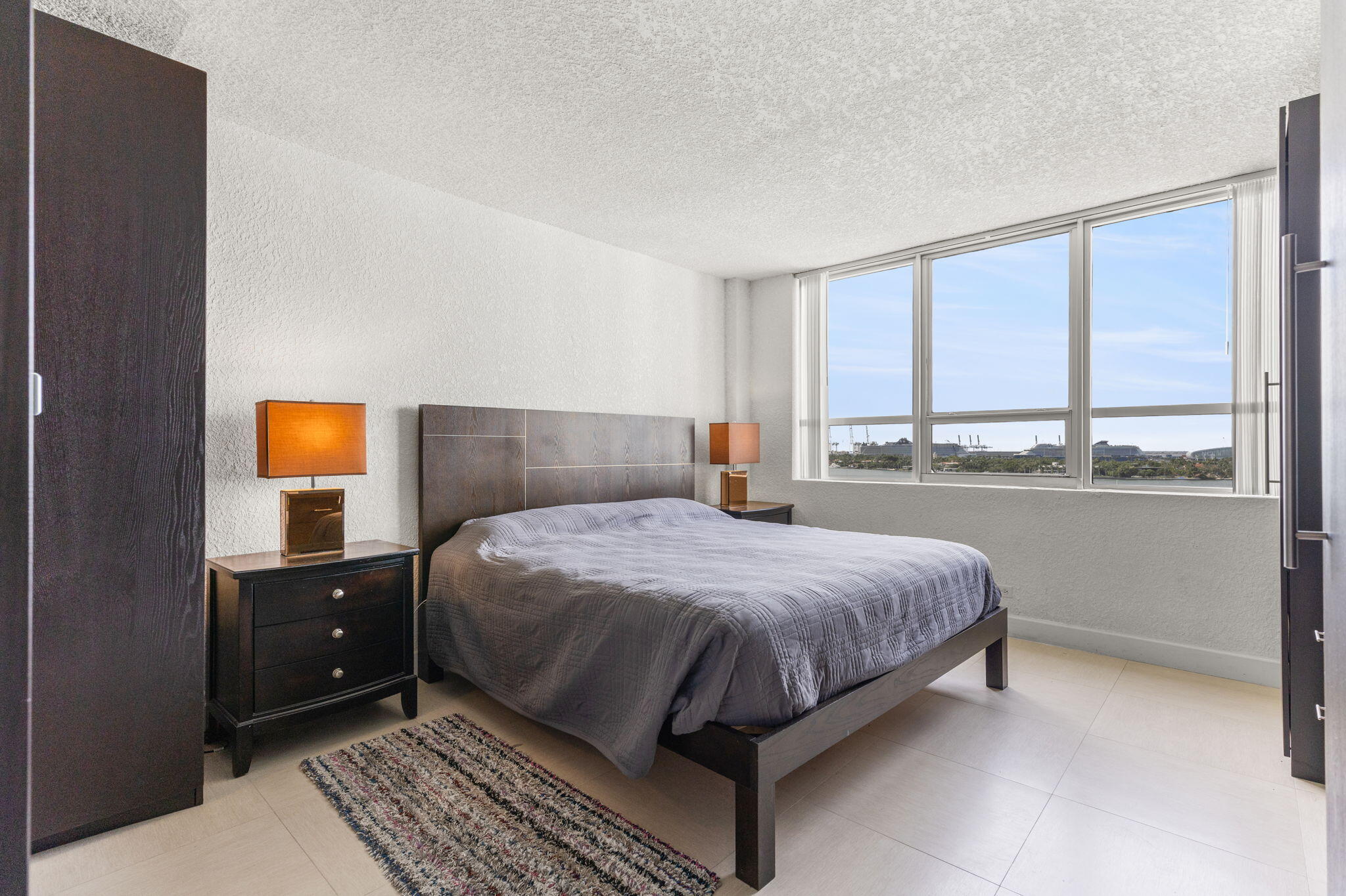 1500 Bay Road, Unit 1122S Miami Beach, FL 33139 - Photo 7 of 24 a bedroom with a bed and window
