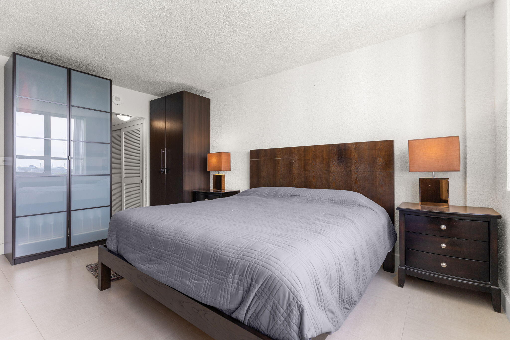 1500 Bay Road, Unit 1122S Miami Beach, FL 33139 - Photo 10 of 24 a bedroom with a bed and a dresser