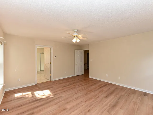 a view of an empty room and wooden floor