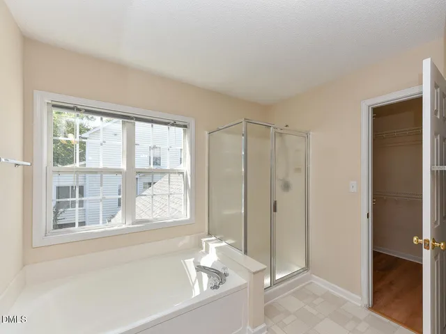 a bathroom with a bathtub and a shower