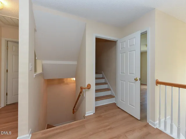 a view of a hallway with wooden floor and entryway