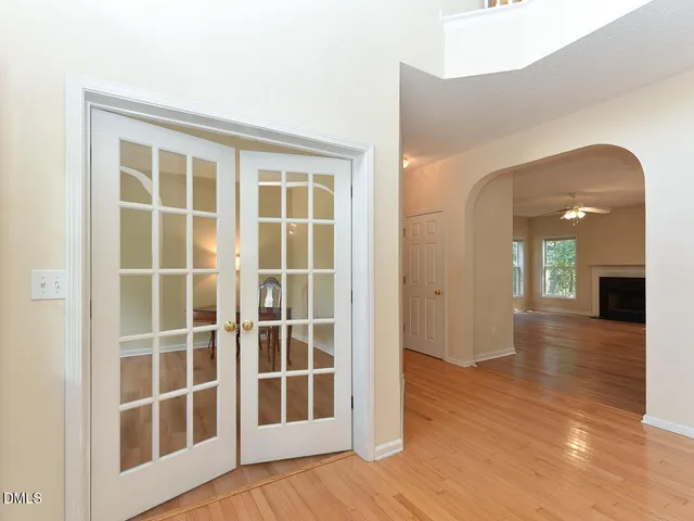 a view of empty room with wooden floor