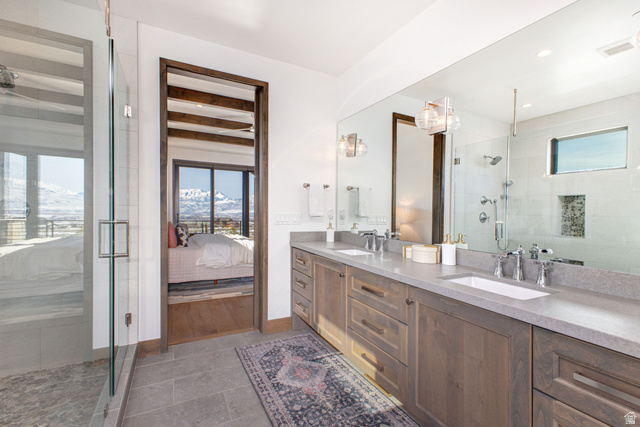 1282 Chimney Rock Road, Unit 344 Heber City, UT 84032 - Photo 27 of 55 Dual vanity featuring wood-finish cabinetry, under-mount sinks, and extensive counter space