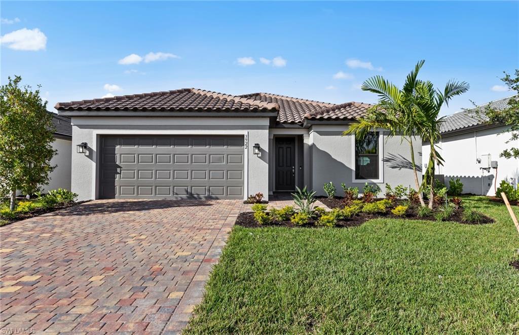 3922 East Hampton Circle Fort Myers, FL 33905 - Photo 1 of 24 a front view of a house with a yard