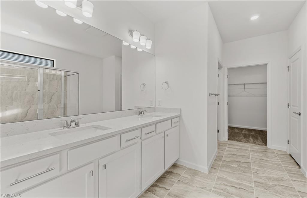 3922 East Hampton Circle Fort Myers, FL 33905 - Photo 15 of 24 a spacious bathroom with a shower sink and mirror