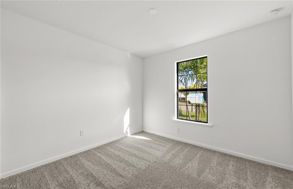 3922 East Hampton Circle Fort Myers, FL 33905 - Photo 18 of 24 an empty room with windows and mirror