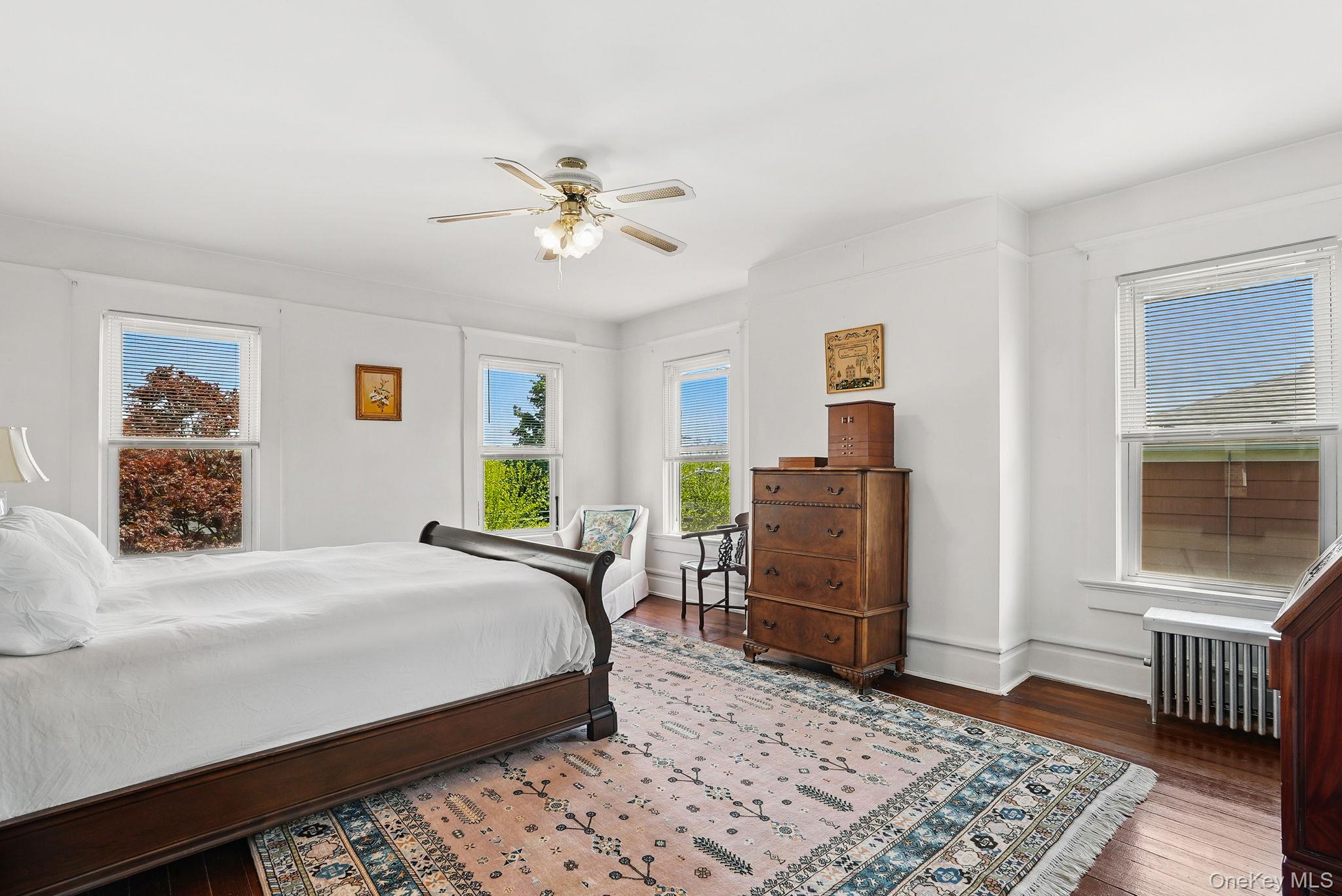 134 Old Mamaroneck Road White Plains, NY 10605 - Photo 11 of 23 a bedroom with a bed dresser and wooden floor