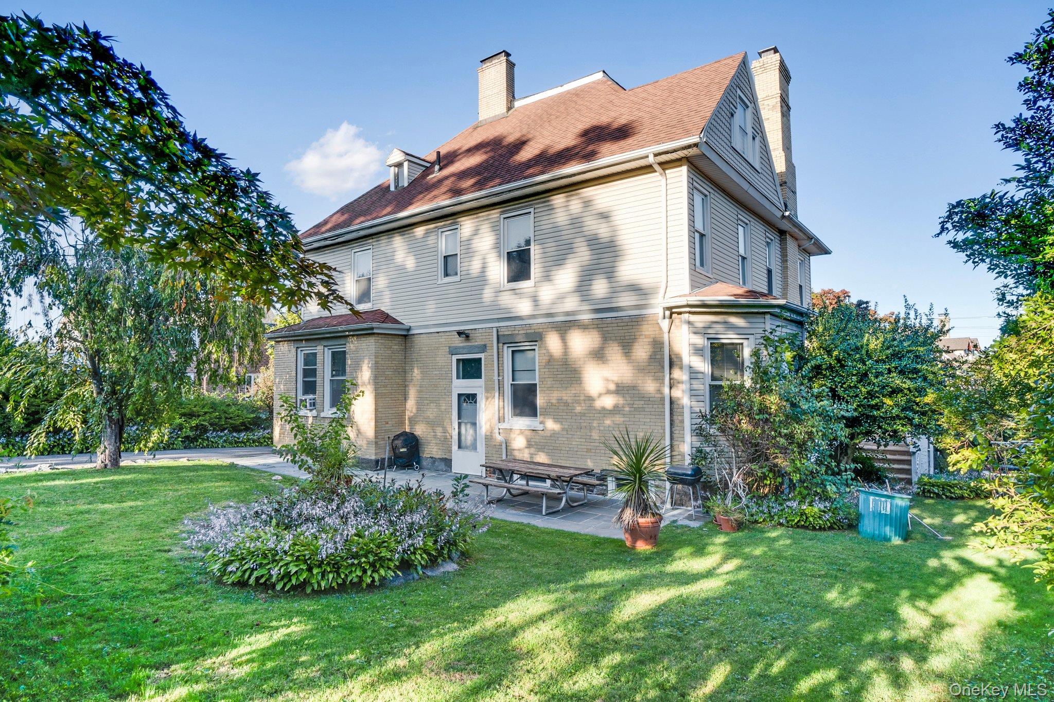 134 Old Mamaroneck Road White Plains, NY 10605 - Photo 20 of 23 a view of a house with a yard and potted plants