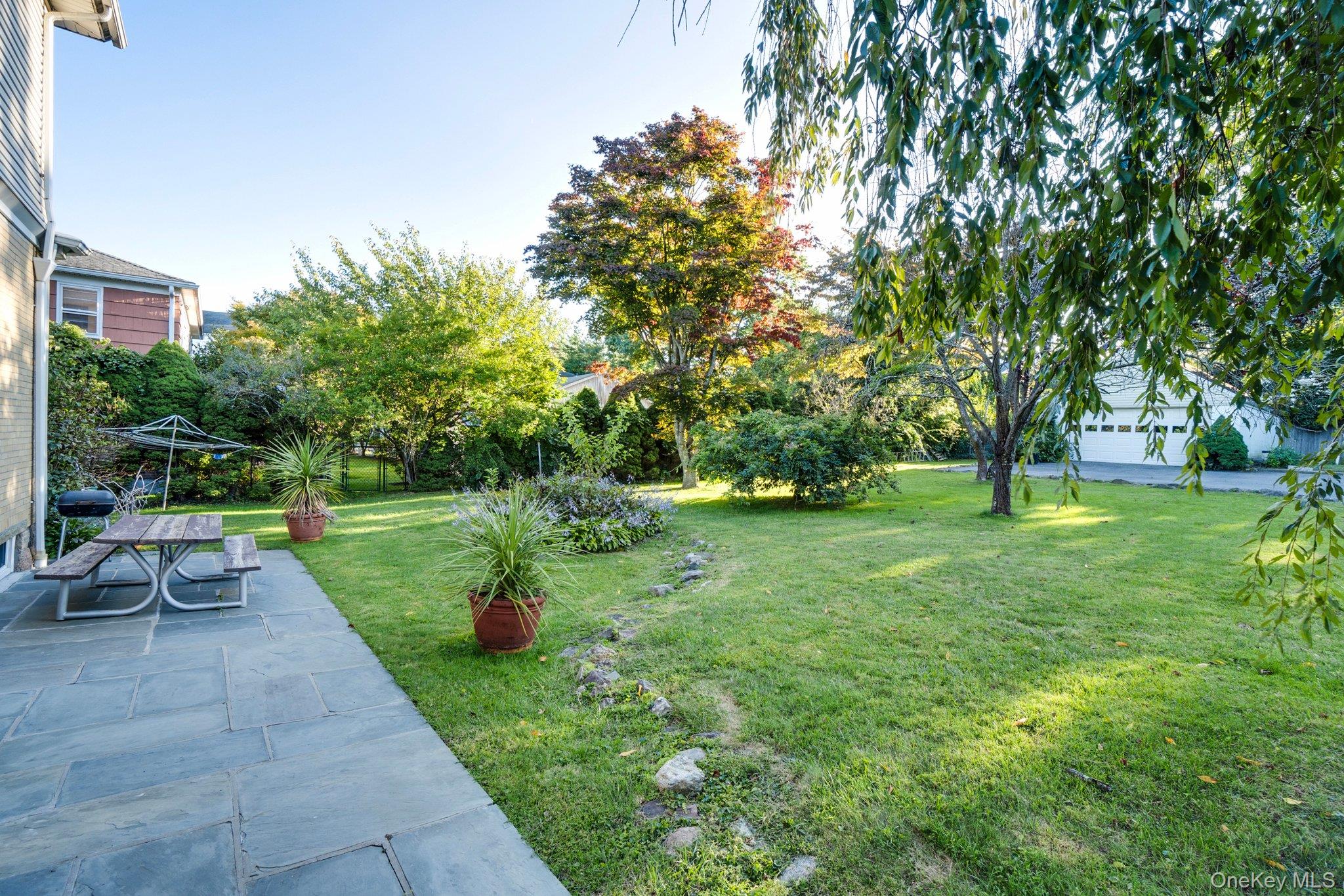 134 Old Mamaroneck Road White Plains, NY 10605 - Photo 21 of 23 a view of a garden with trees