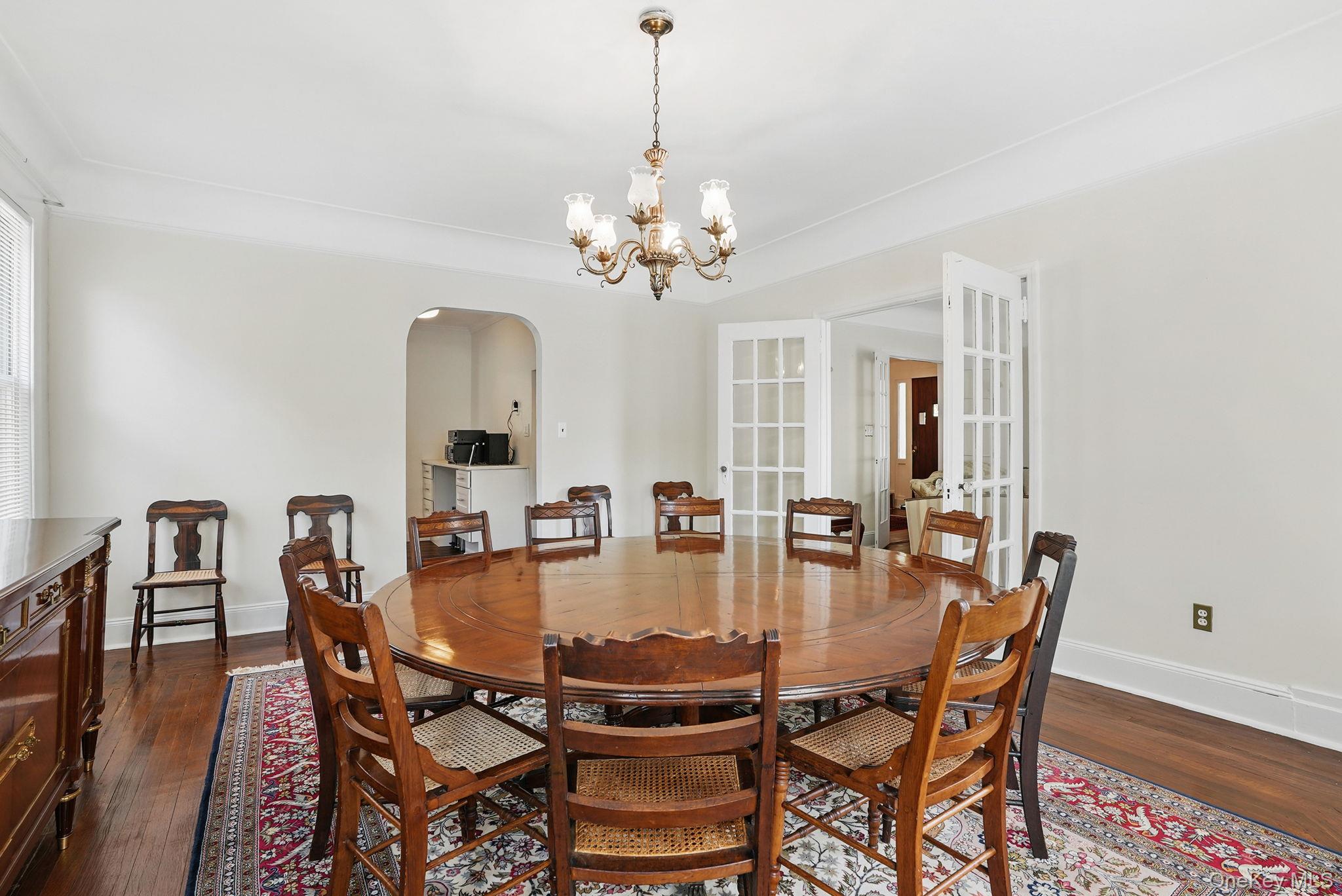 134 Old Mamaroneck Road White Plains, NY 10605 - Photo 7 of 23 a dining room with furniture a chandelier and wooden floor
