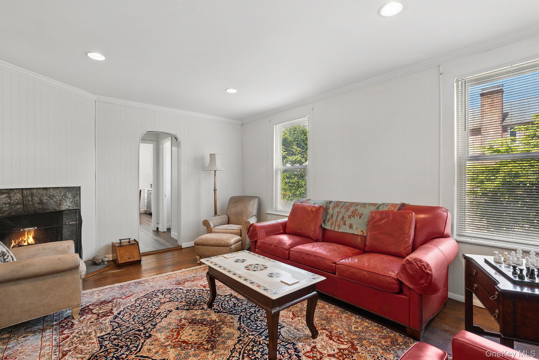 134 Old Mamaroneck Road White Plains, NY 10605 - Photo 8 of 23 a living room with furniture a fireplace and a table