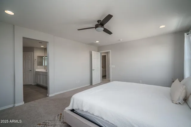 a bedroom with a large bed and a window